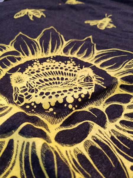 Sunflower & Honey Bees Women's T-shirt. Start wearing your new favorite shirt now. Soft, modern and original.   Super soft triblend material in vintage black, flower and bees printed in gold yellow.  Preshrunk, true to size dolman.  FREE package of wildflower seeds with your order. Help provide nectar, pollen and shelter to our beloved pollinators.  We Love Bees!!