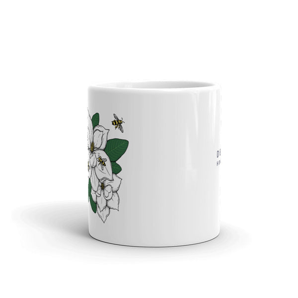 Decker Honeybees Magnolia Mug. Whether you're drinking your morning coffee, your evening tea, or something in between – this mug's for you! It's sturdy and glossy with our new original design. Just add honey! Ceramic. Dishwasher and microwave safe. White and glossy
