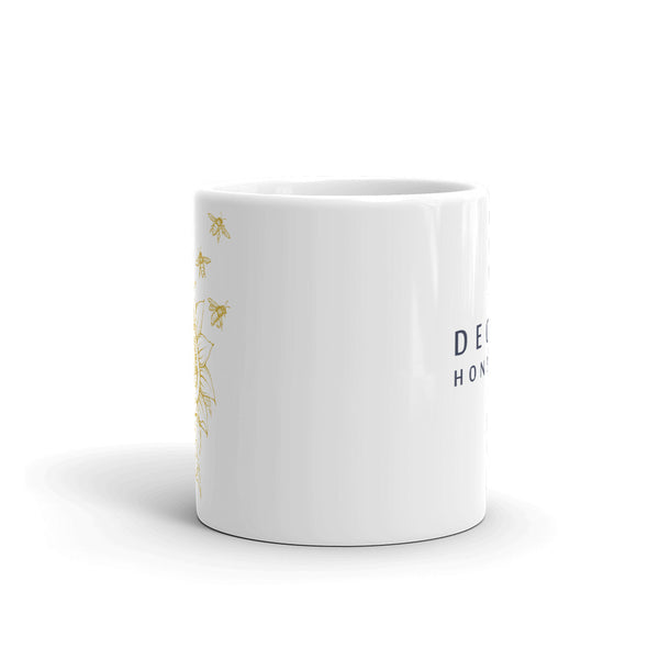 Decker Honeybees Sunflower Mug. Whether you're drinking your morning coffee, your evening tea, or something in between – this mug's for you! It's sturdy and glossy with beuatiful original art that'll withstand the microwave and dishwasher. Ceramic. Dishwasher and microwave safe. White and glossy