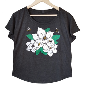 Magnolia & Honey Bees Women's T-shirt. We've created a beautiful new design that captures southern style, charm and our love of bees. Magnolias are one of our favorites and this design is so realistic, you can almost smell the sweetness.  Buttery soft triblend material in vintage black, flowers and bees in multiple colors. True to size dolman, preshrunk.  FREE package of wildflower seeds with your order.