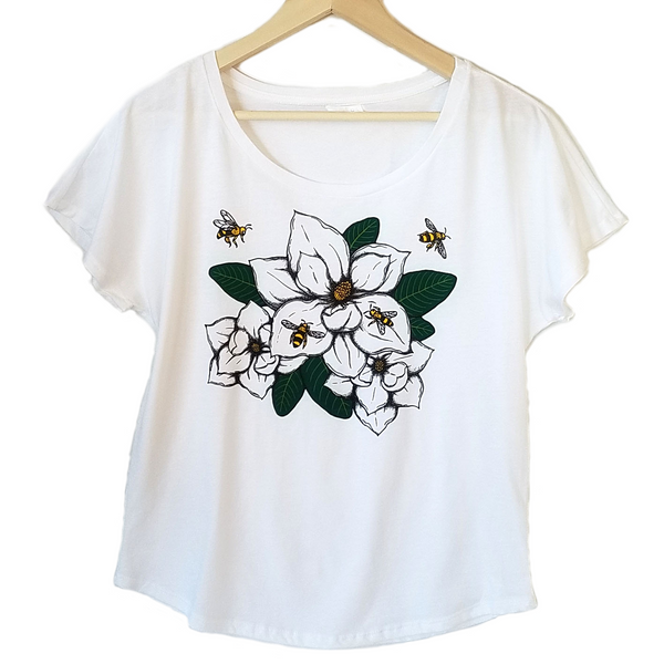 Magnolia & Honey Bees Women's T-shirt. We've created a beautiful new design that captures southern style, charm and our love of bees. Magnolia's are one of our favorites and this design is so realistic, you can almost smell the sweetness.  Silky soft cotton/poly blend, true to size dolman, tearaway label.  FREE package of wildflower seeds with your order.