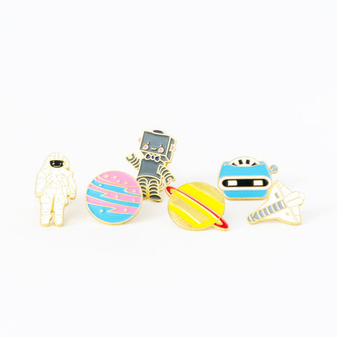 Space & Floral Enamel Pins. This is a great bunch of hard enamel pins to satisfy any space buff. With a retro style and some bright colors, make your outfit pop.  Mix and match and make a personal statement. 